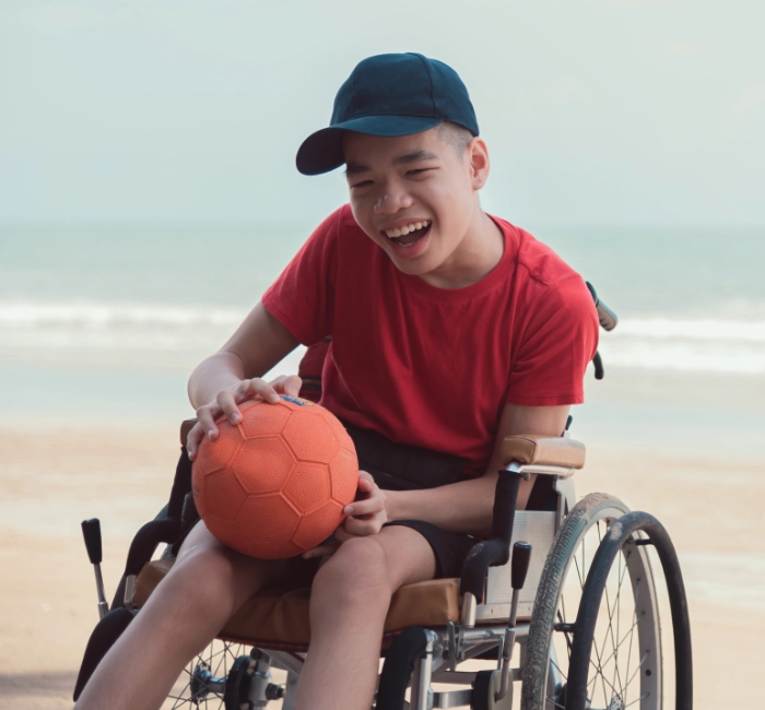 happy-disabled-teenage-boy-playing-ball